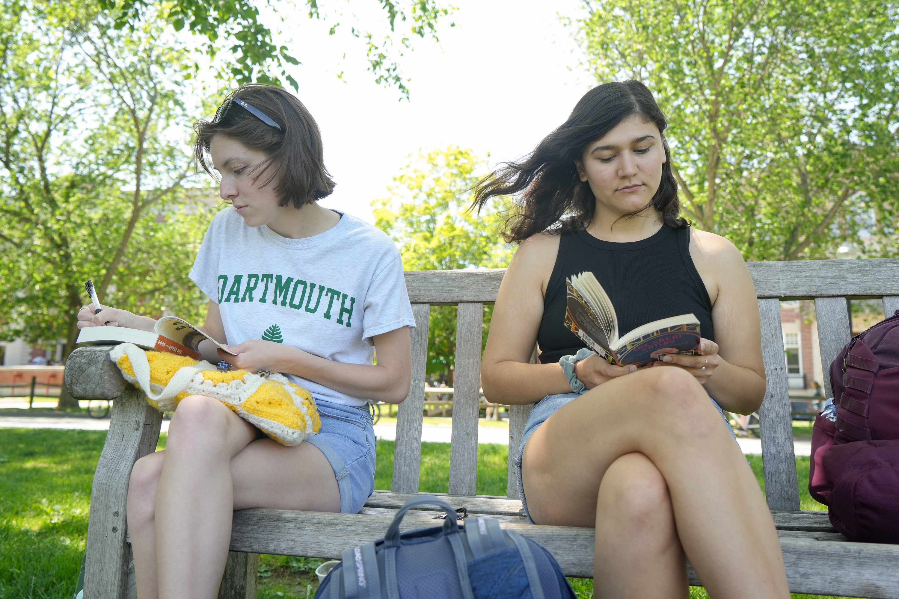 Two students on a bench by the Green