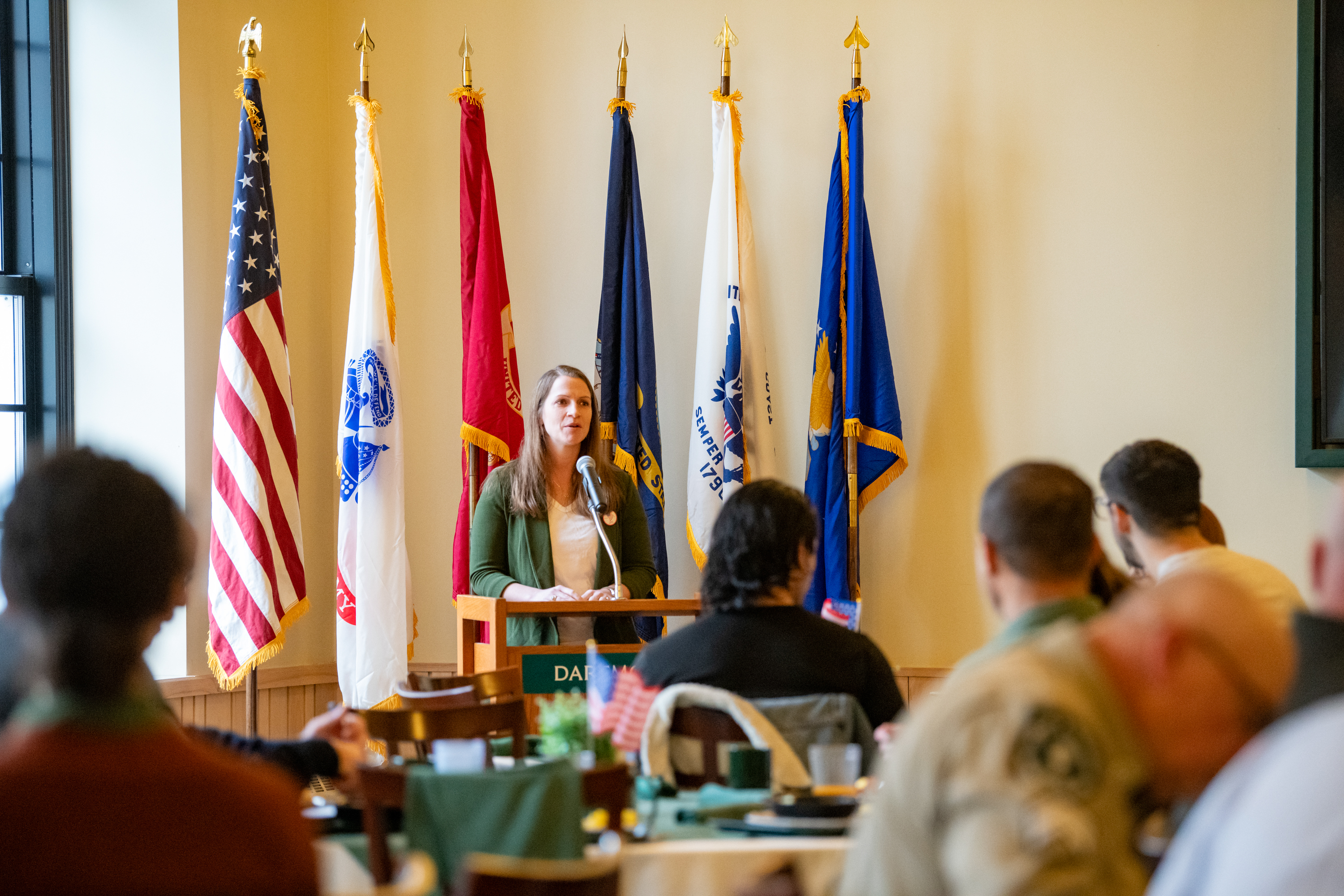 Morgan Ogreen at the podium during Veterans Day breakfast