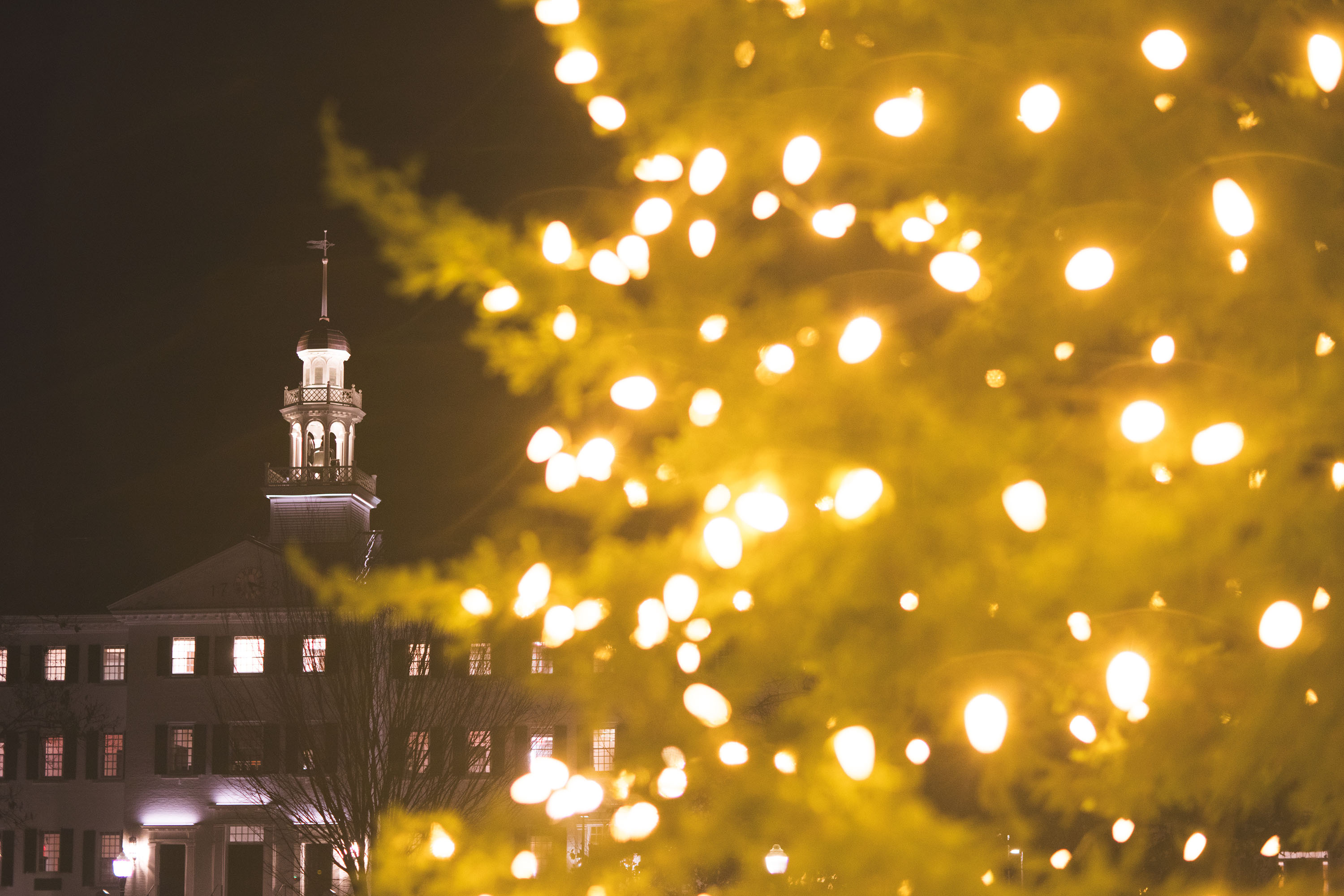 Dartmouth Hall framed by lit tree branches