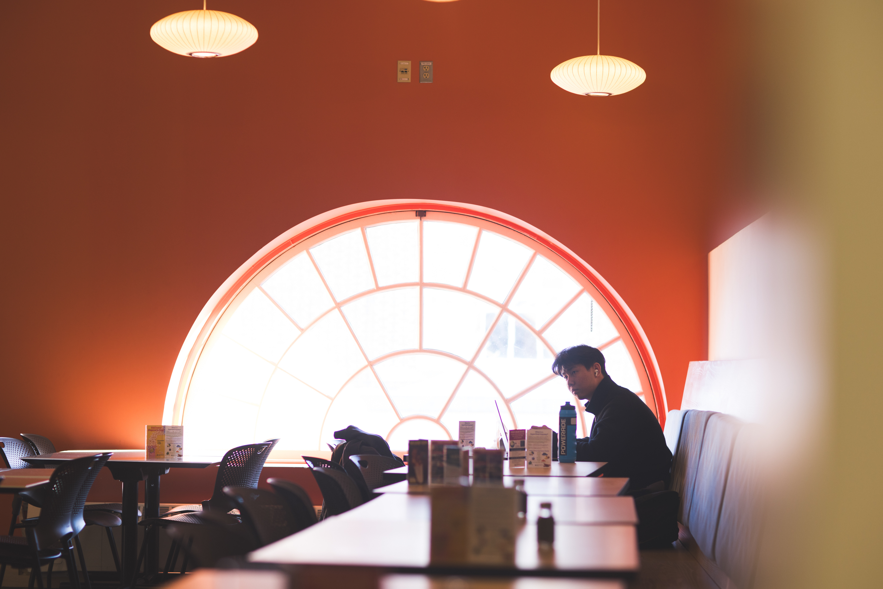 A student sits in the dining hall