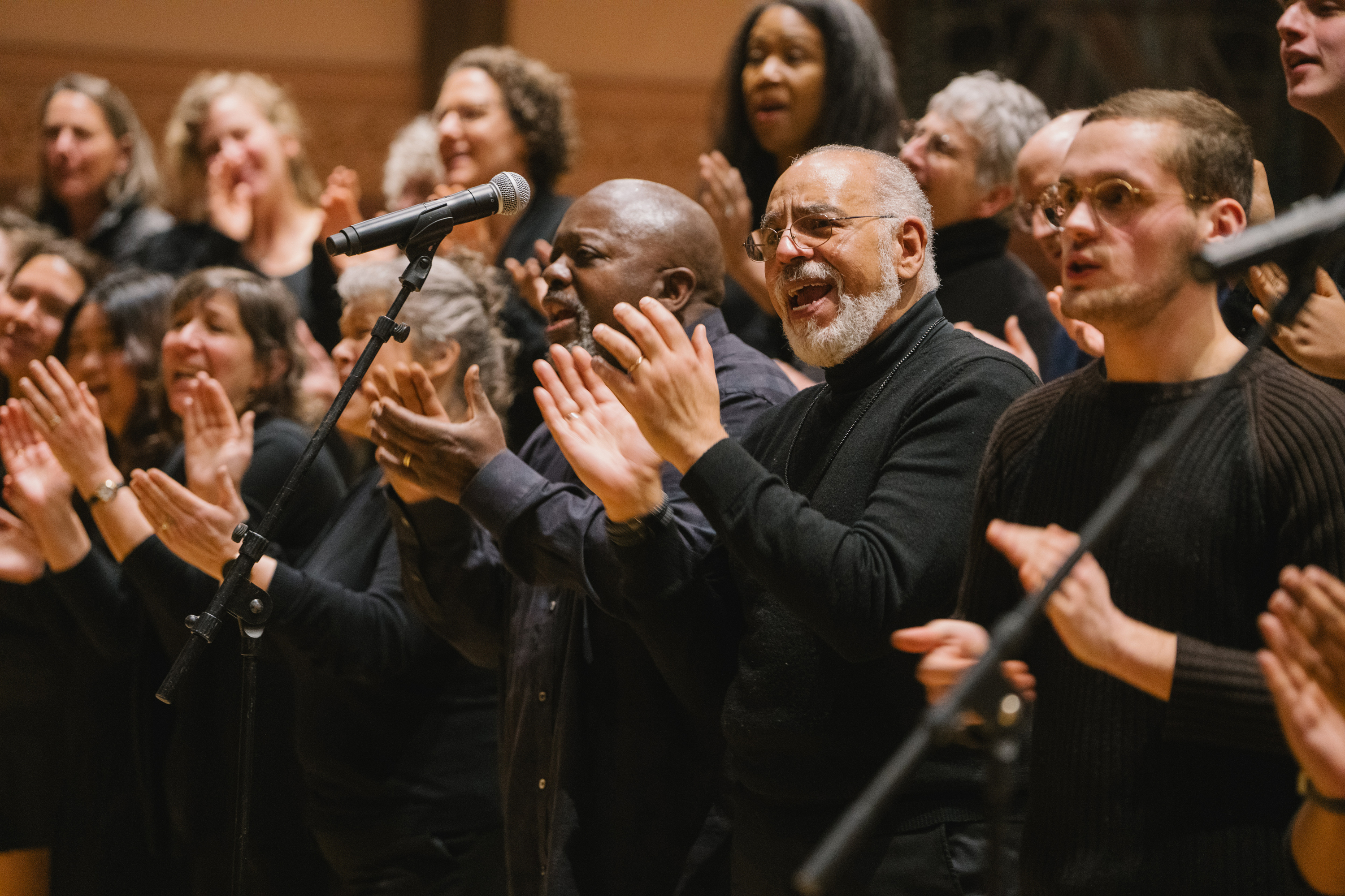 Gospel Choir members sing and clap