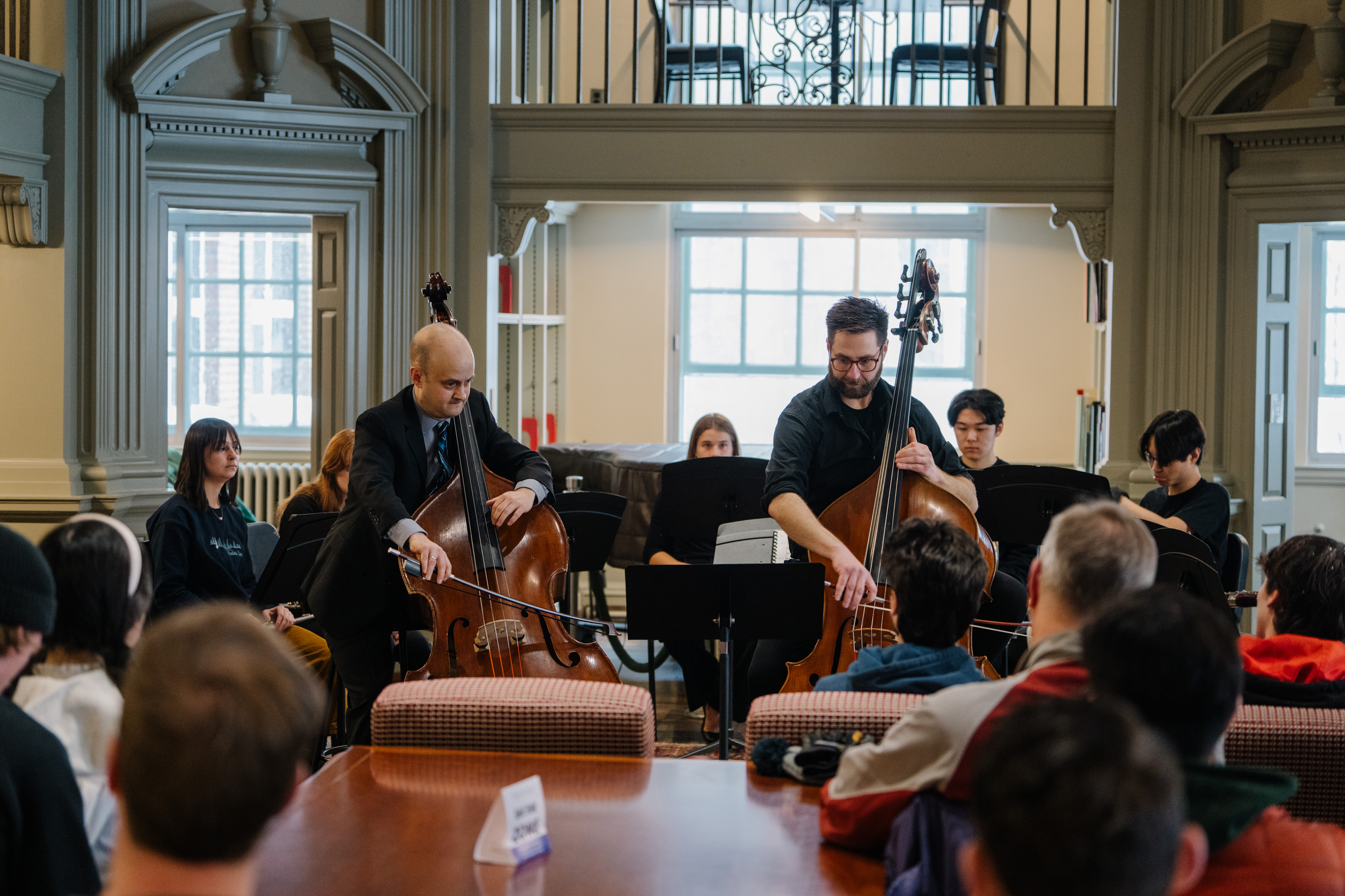 U.S. Navy Band principal bassist Kyle Augustine and double bass faculty Nick Browne with student musicians.