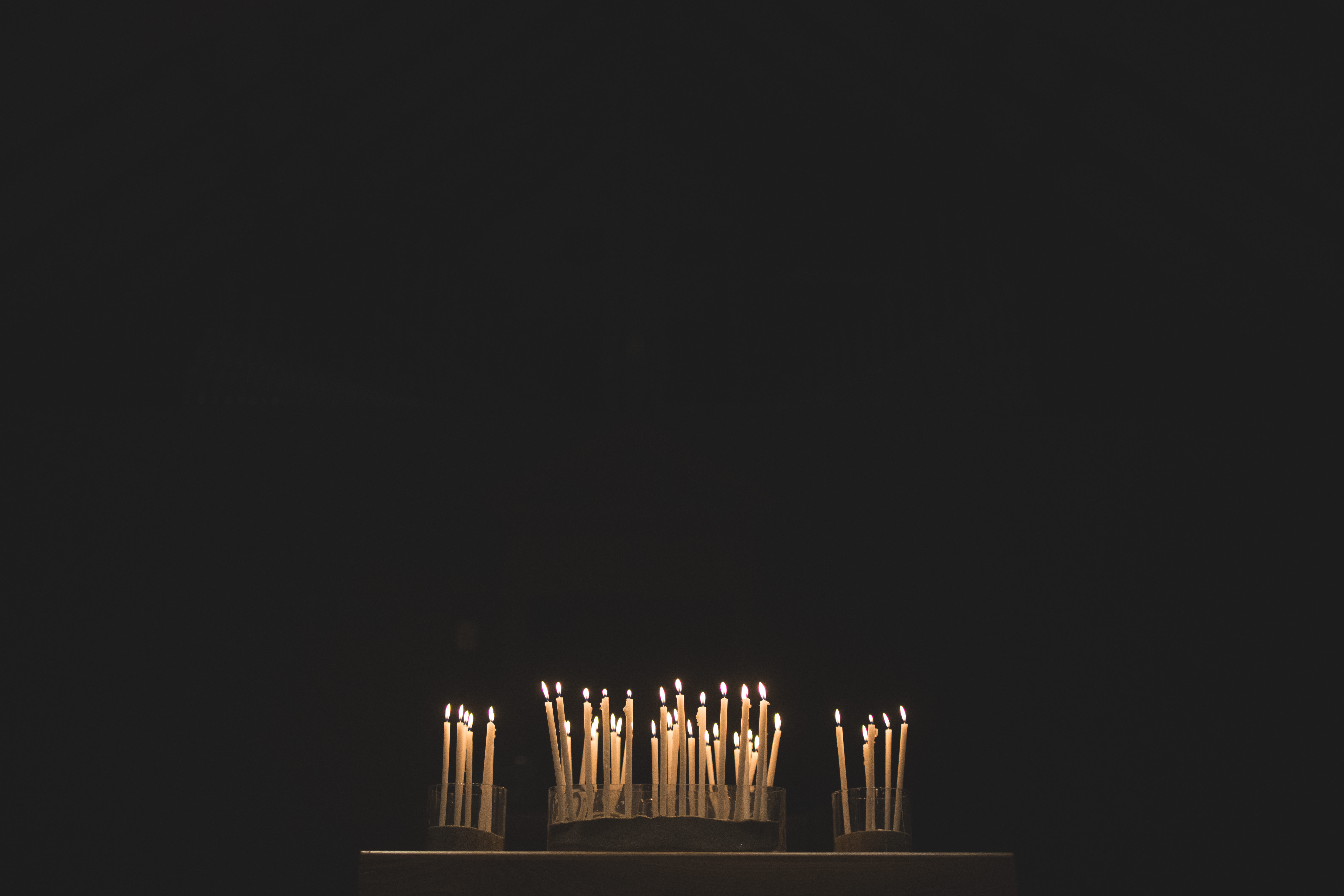 Candles lit in a dark space