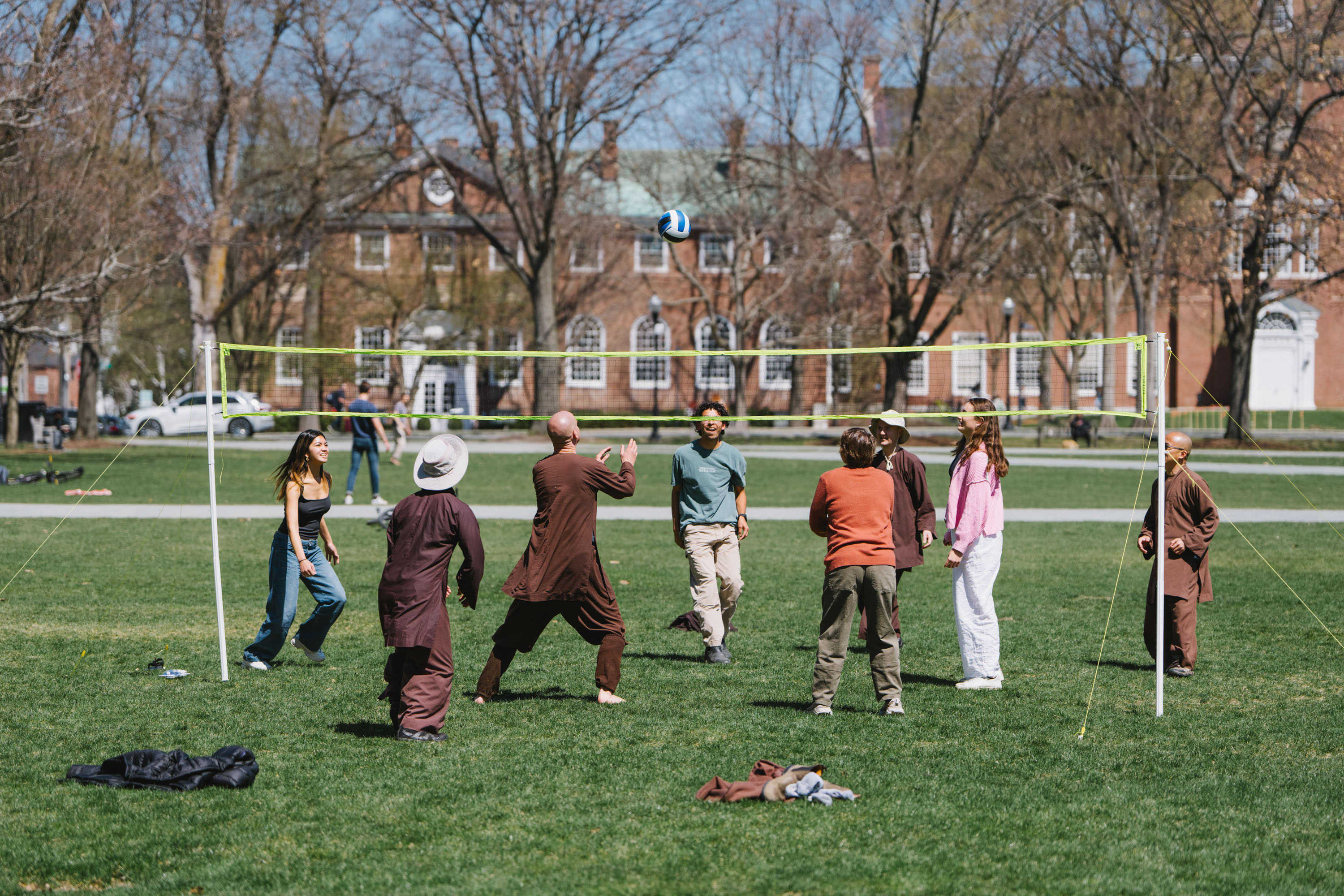 Monks play volleyball with students