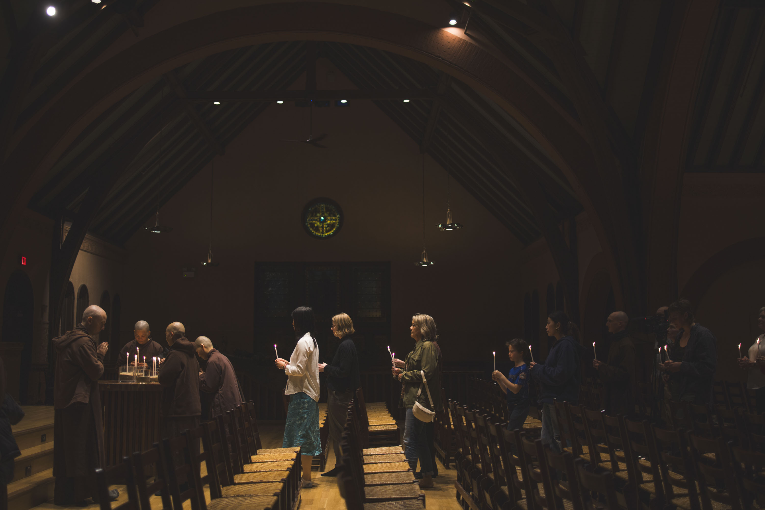 People with candles in line at Rollins Chapel
