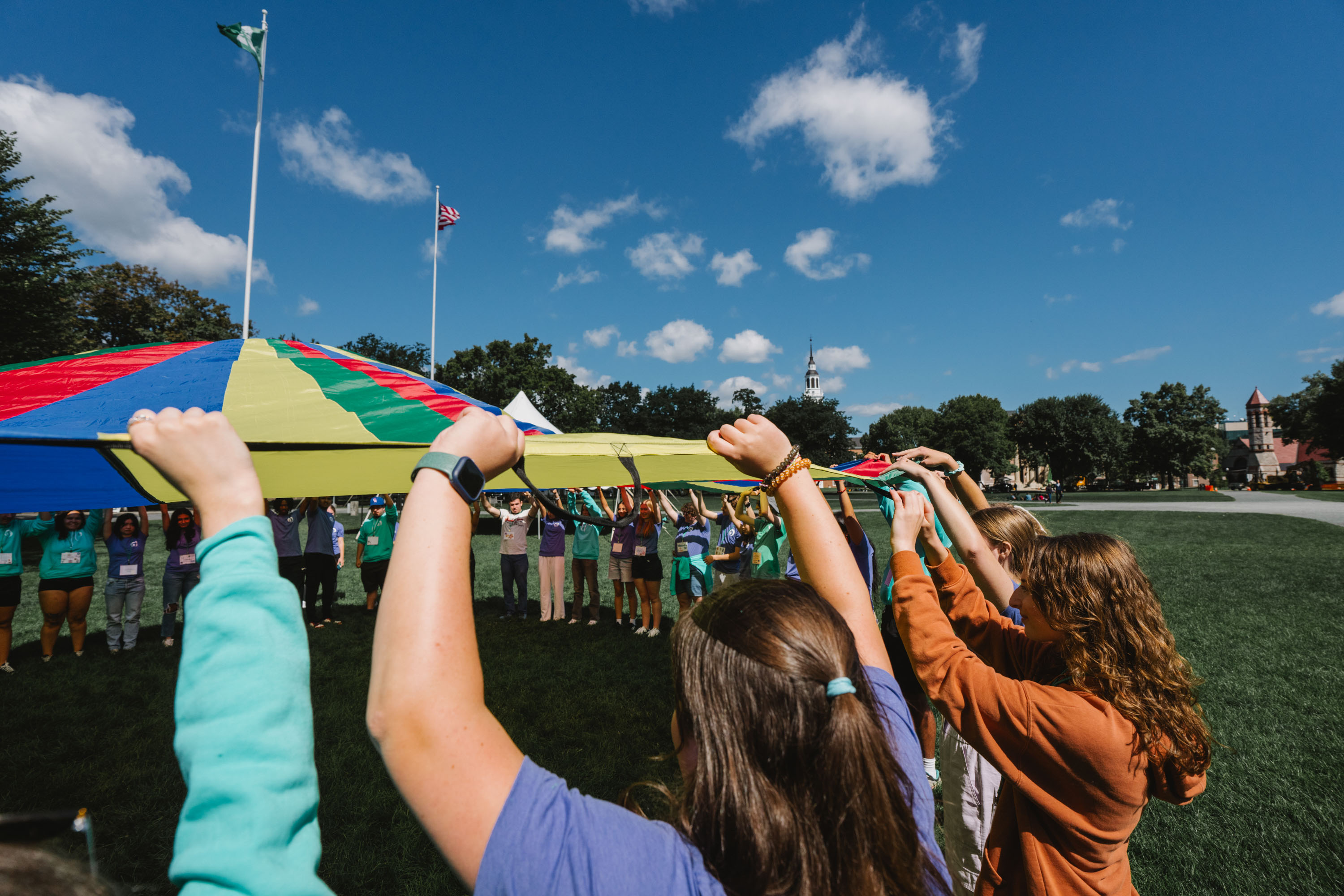 Students lift rainbow tent up