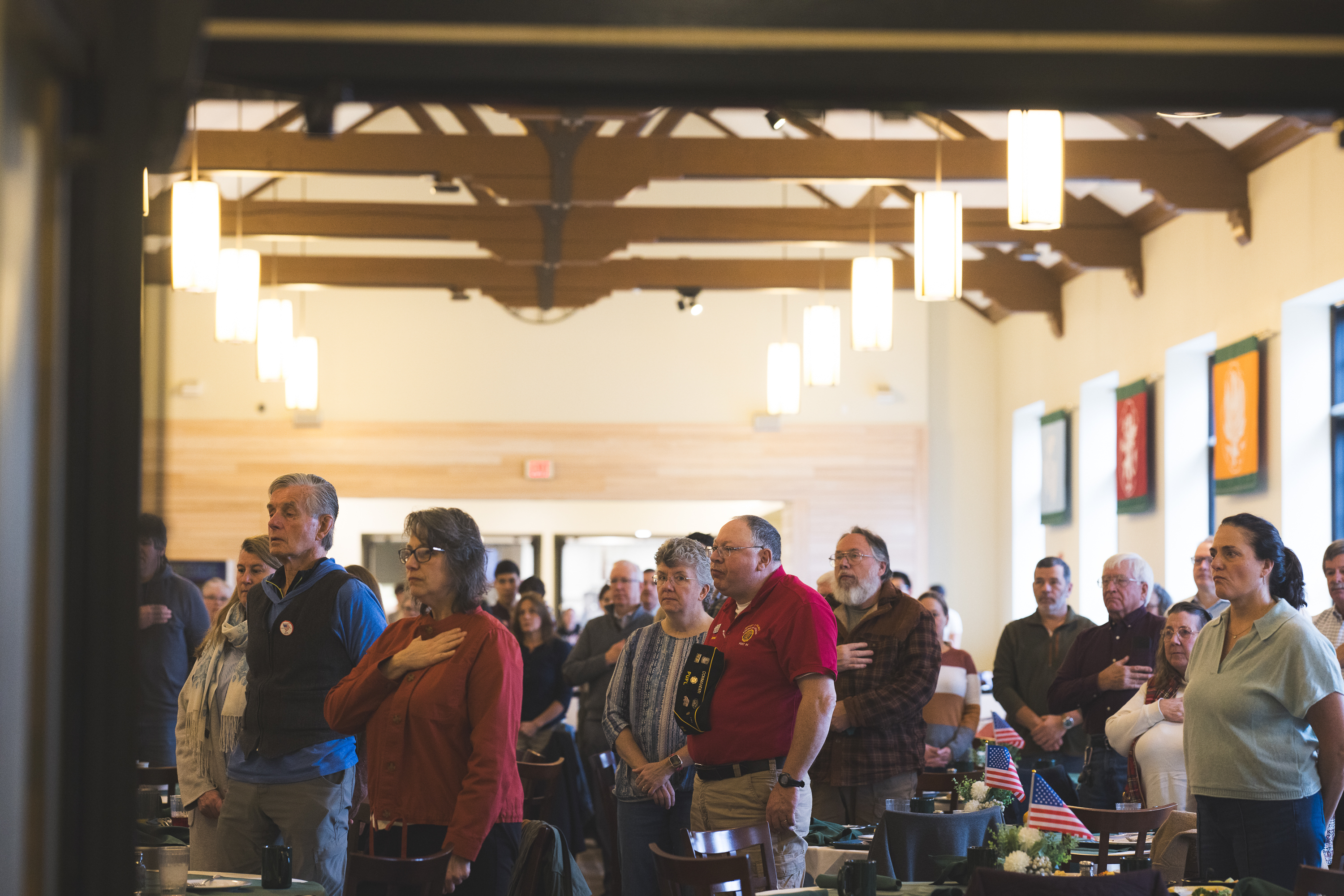 Breakfast attendees standing for the national anthem