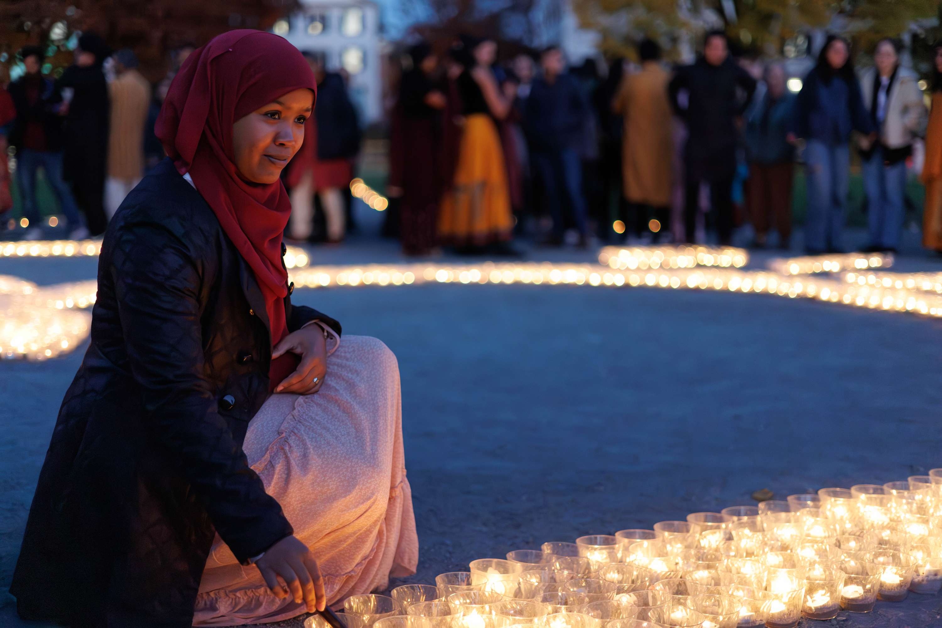 Woman lights candles for Diwali celebration