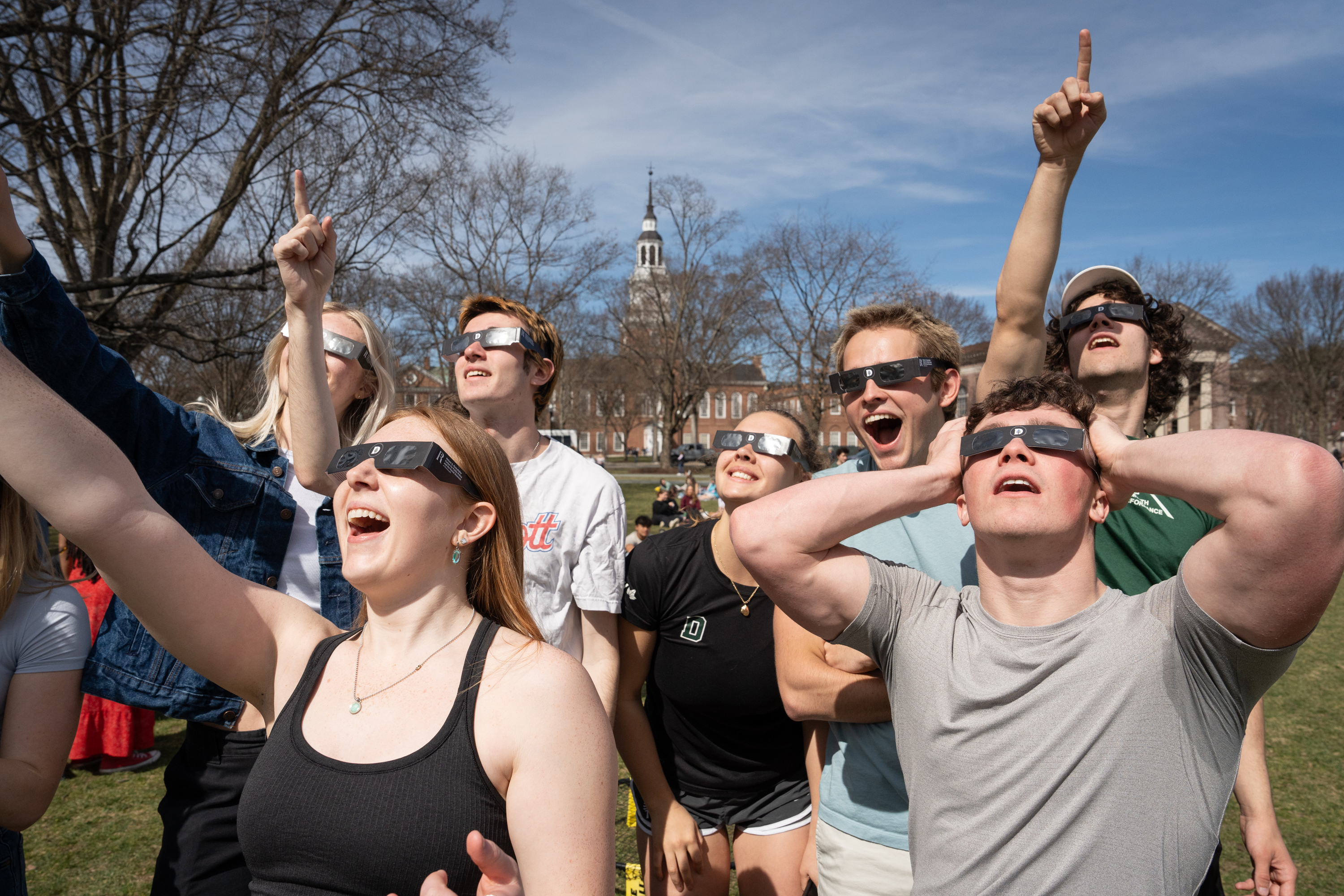 Students with eclipse glasses gazing at the sun