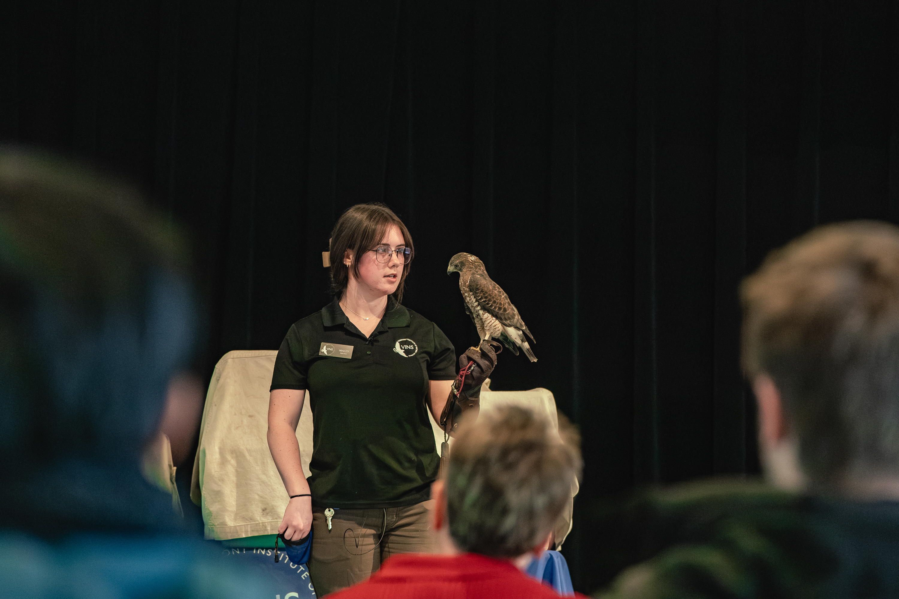Macey Alderman holding a broad-winged hawk