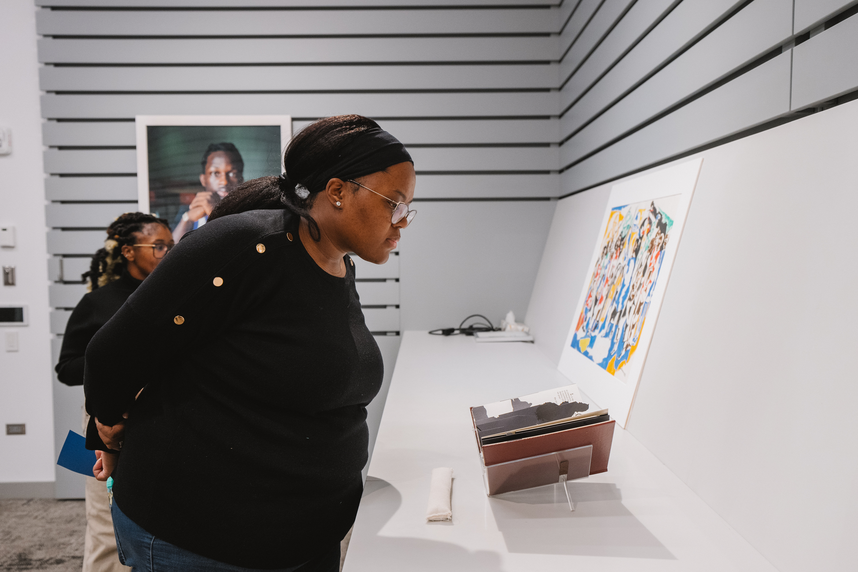 Ashley T. Audu looking at items on display at the Hood