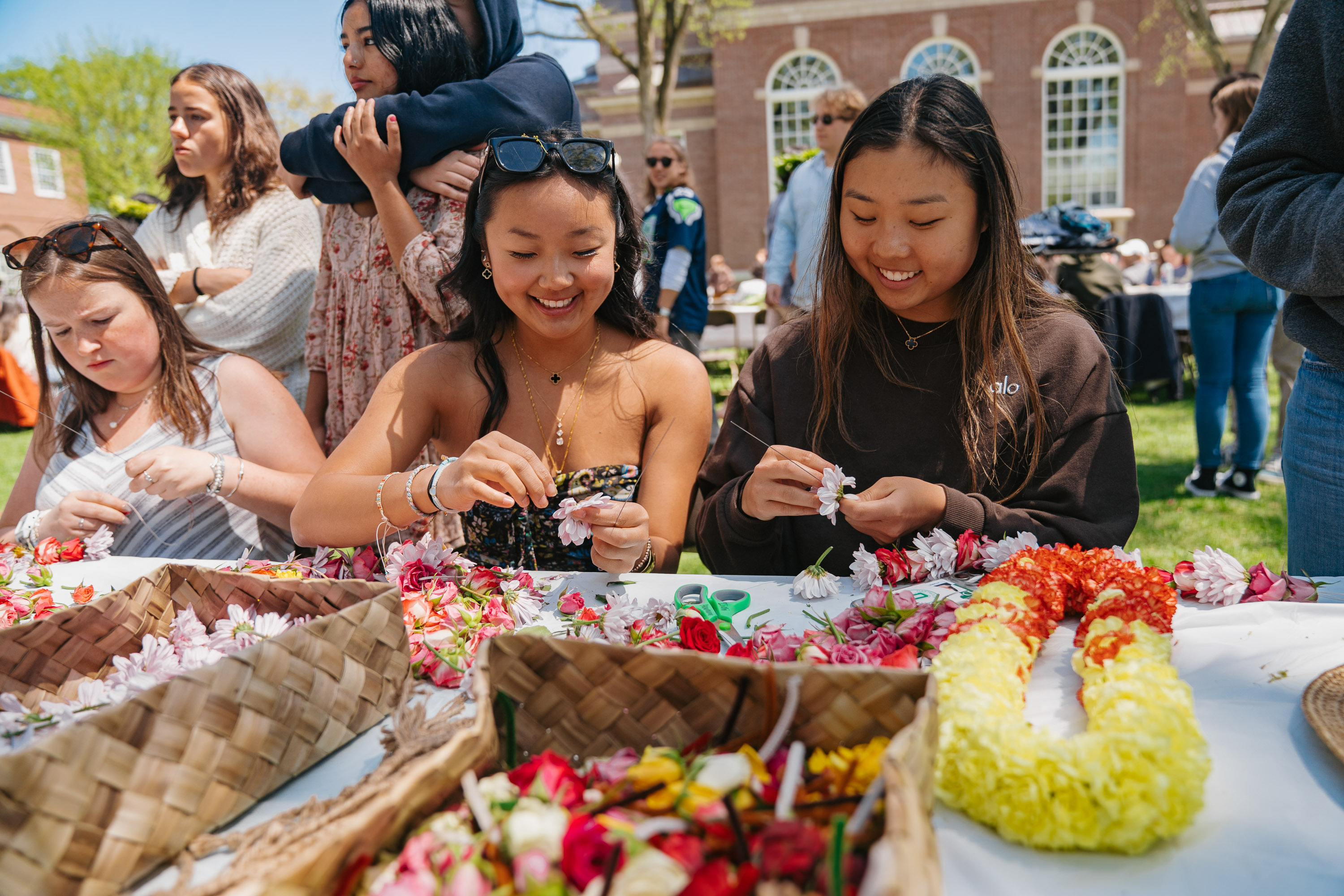 Students constructing leis together