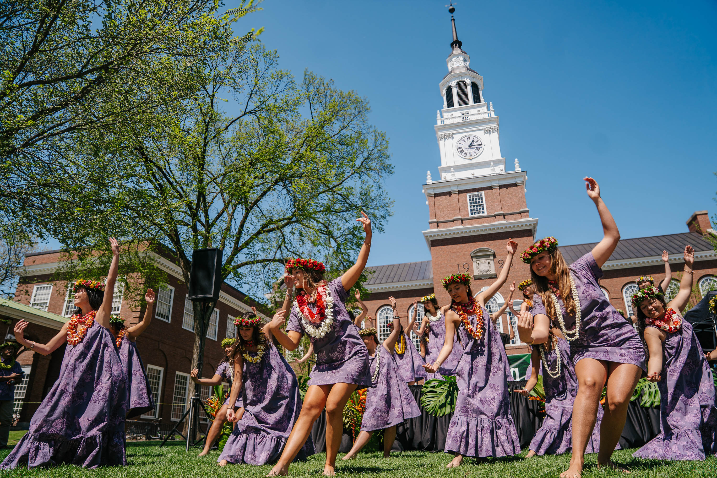 Students dance in front of Baker Tower in festive apparel