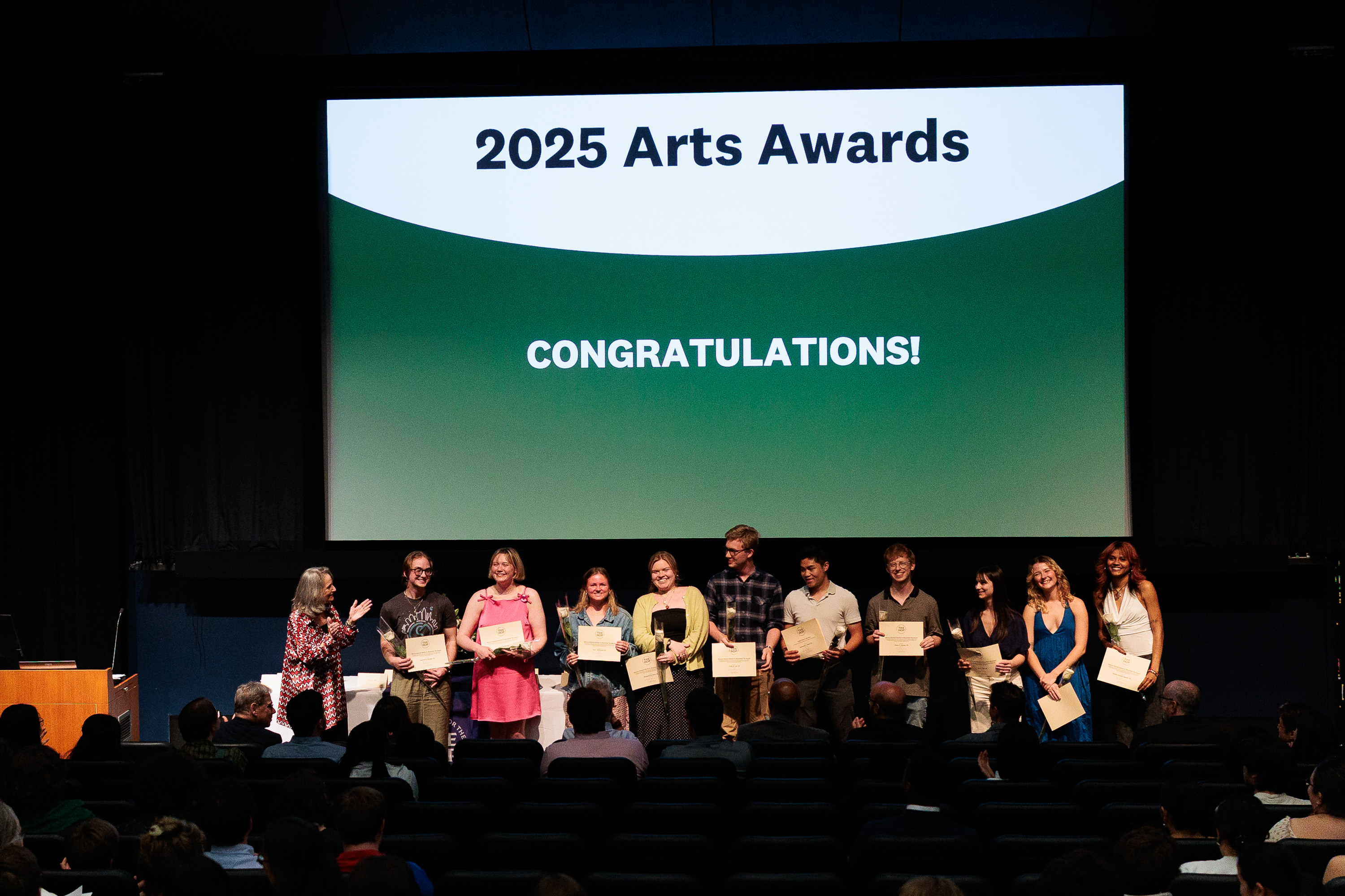 Hop Arts Awards winners standing under a projector that reads "2025 Arts Awards, CONGRATULATIONS"