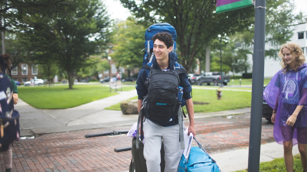 Incoming student carryies multiple bags