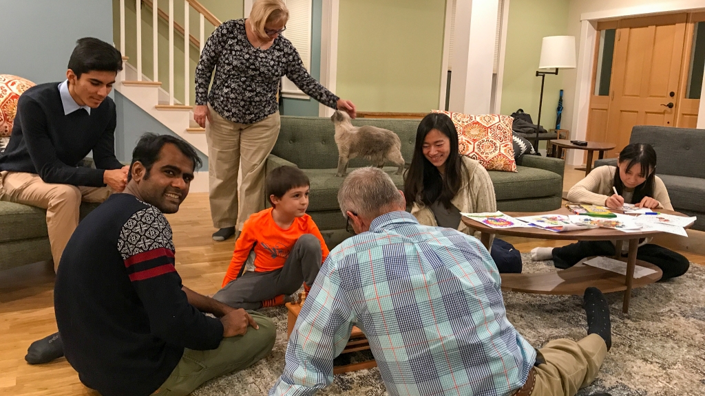Students and members of Janice McCabe's family play games and color