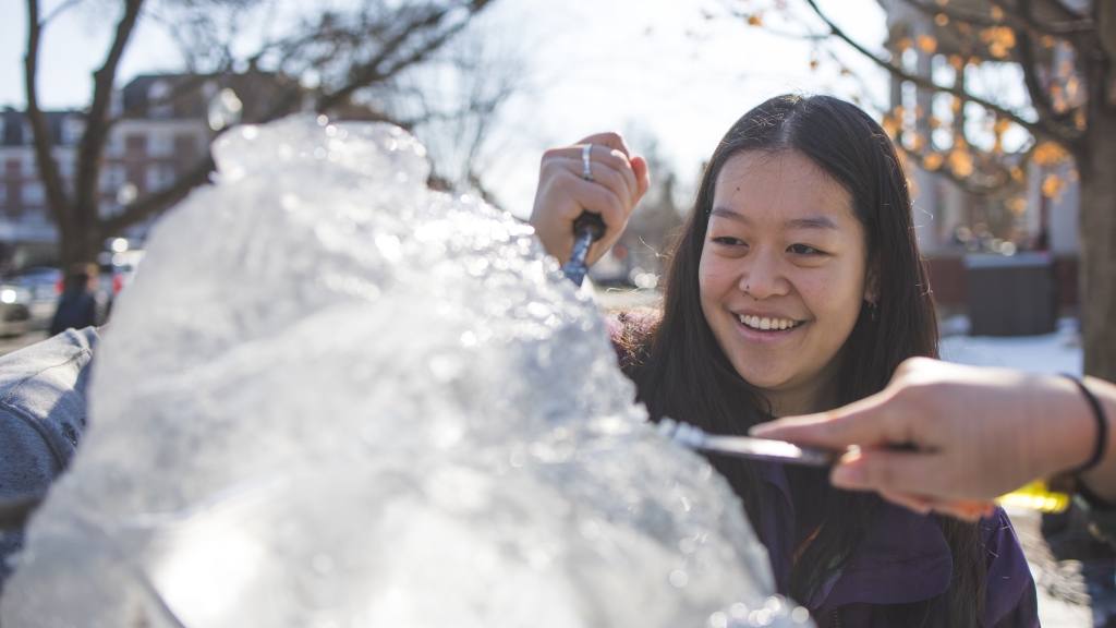 Students carving an ice sculpture