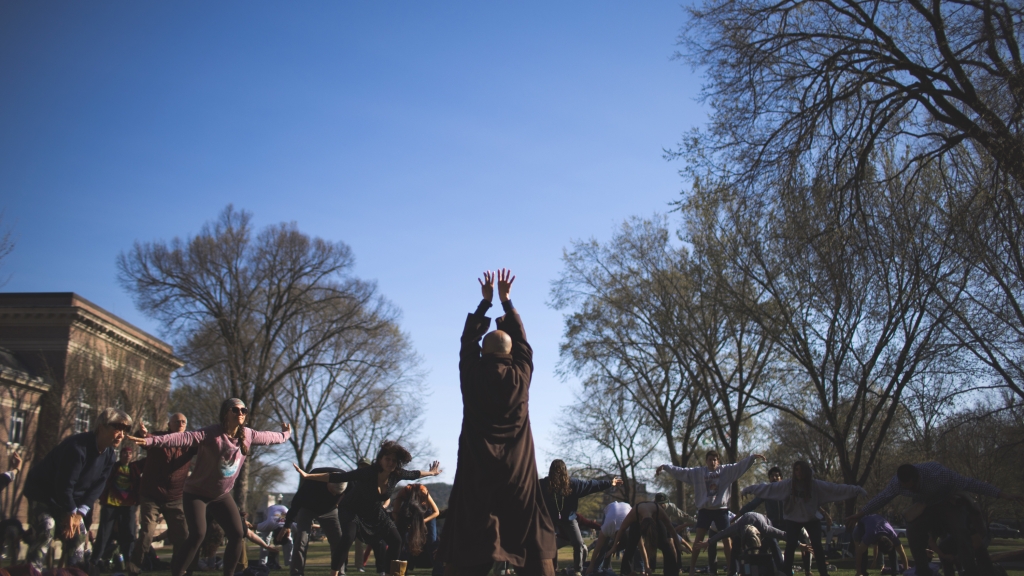 Monks lead students in qigong on the Baker Library lawn