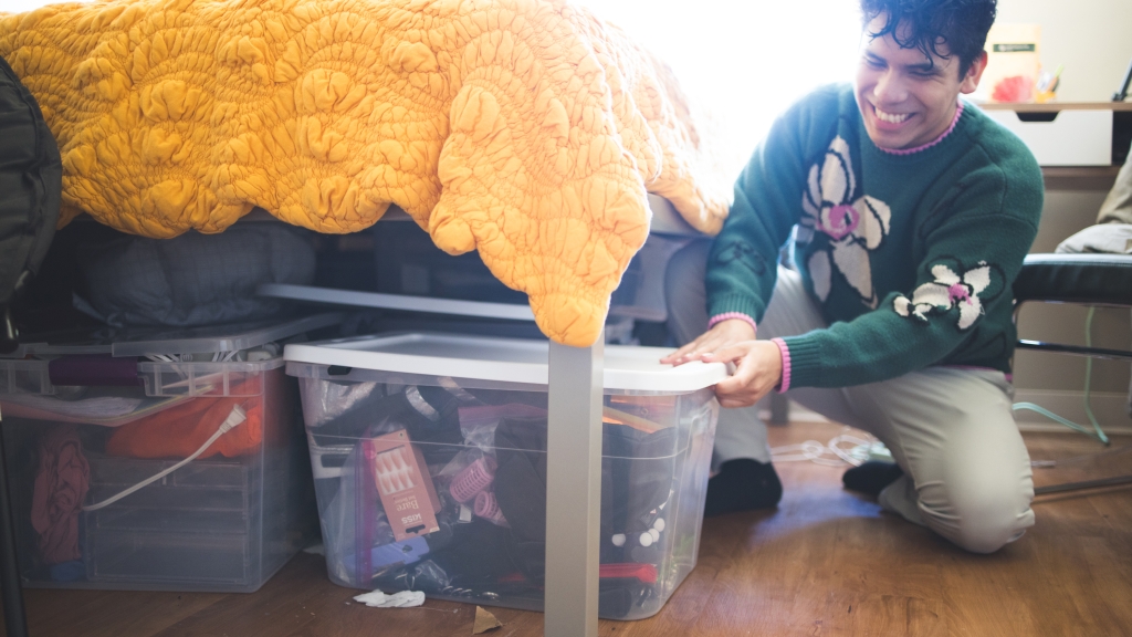 Jaime Aranzabal '24 pulls out a bin full of wardrobe accessories