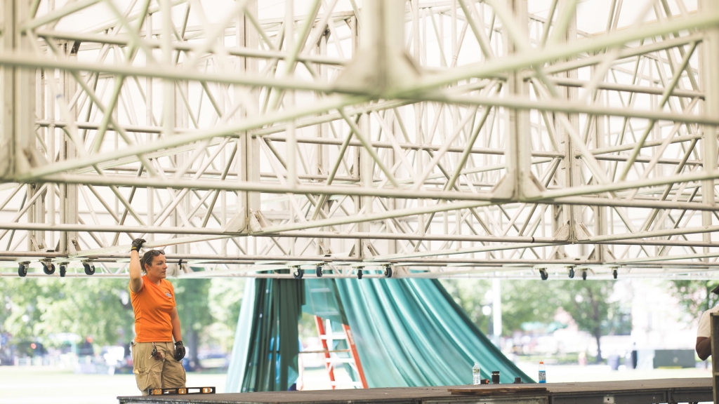 Person sets up the stage for Commencement