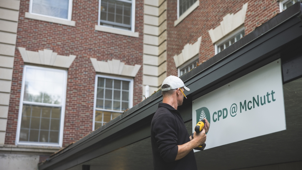 Mike Sauer hanging a sign