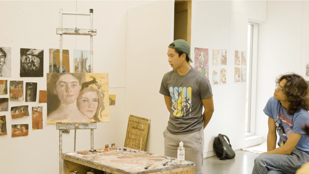 A student looks at a painting during class