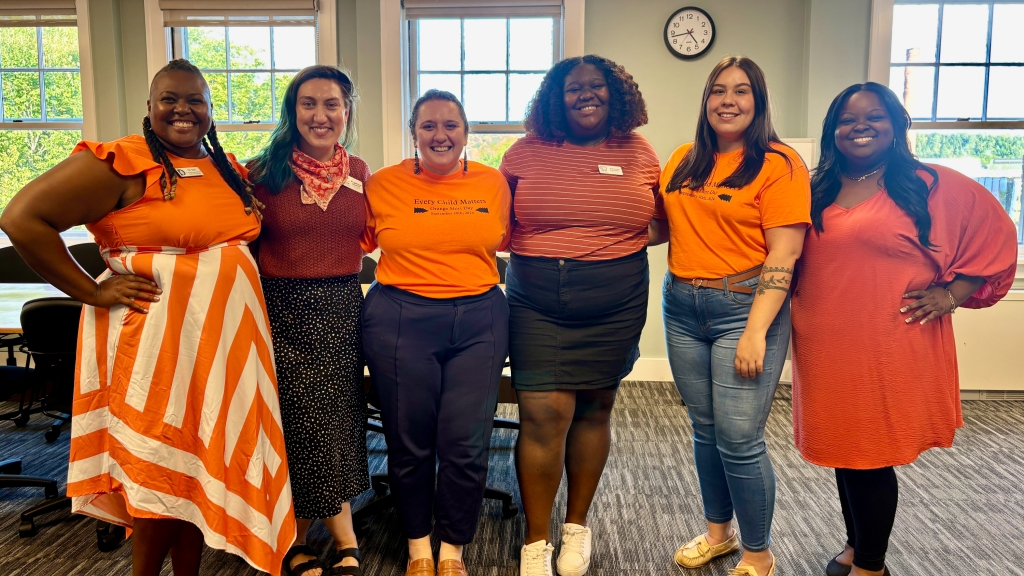 Staff in orange shirts