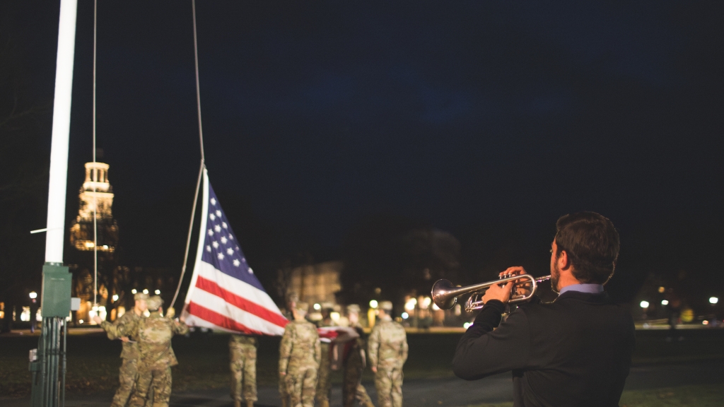 Dartmouth ROTC students next to the U.S. flag