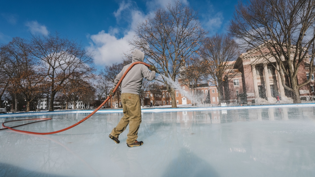 Person flooding ice rink with a hose