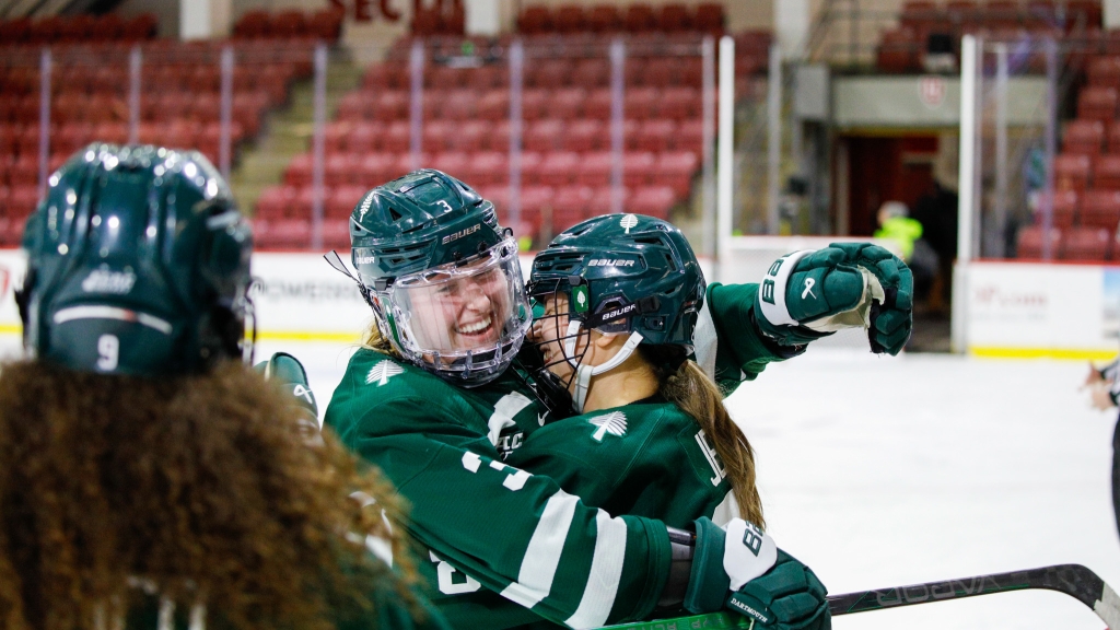 Two women's hockey players hugging
