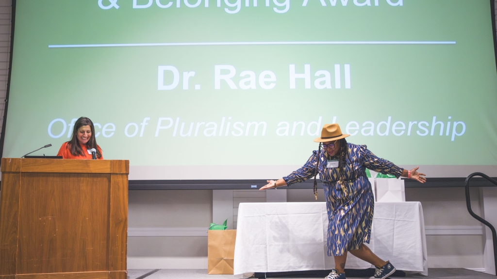 Dr. Rae Hall performing a curtsy on stage
