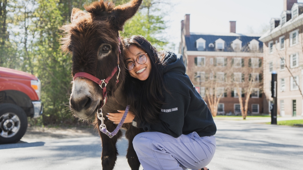 Emily Masuda cuddling a donkey