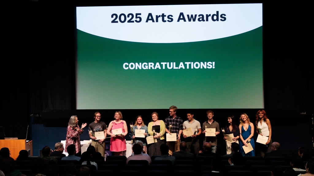 Hop Arts Awards winners standing under a projector that reads "2025 Arts Awards, CONGRATULATIONS"