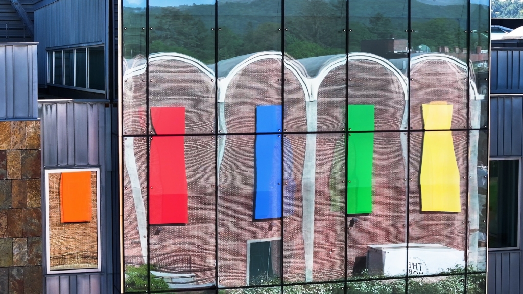 Rainbow art installation reflected in windows